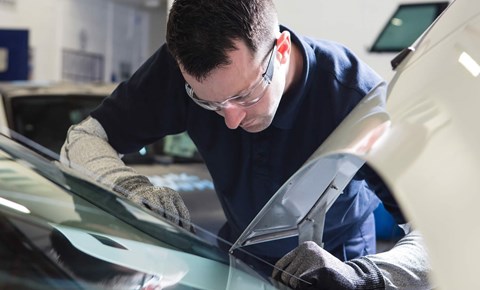 Technician fitting new windscreen